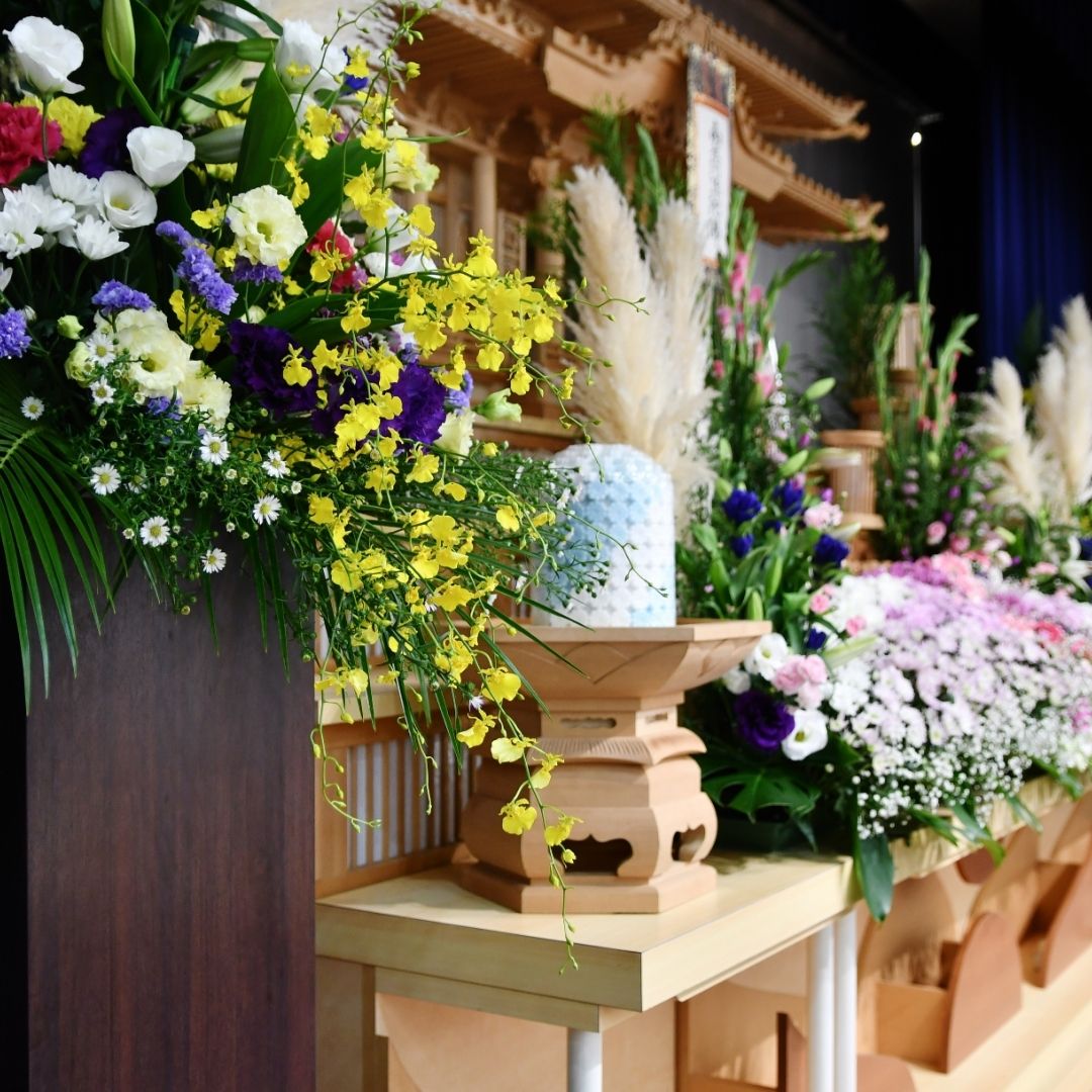 Lectern with memorial photo, flowers, and poetry book prepared for reading poems during a funeral eulogy.