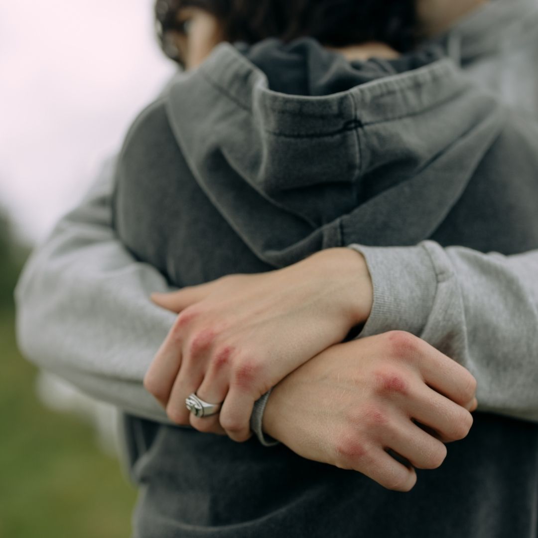 Talking About Grief Parent hugging and comforting a child while supporting them through grief after the loss of a loved one.